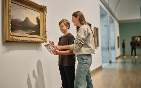 Two students looking at an artwork.